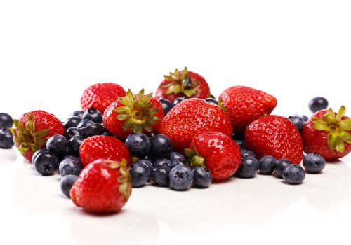 Food, nature. Heap of delicious berries on a white background